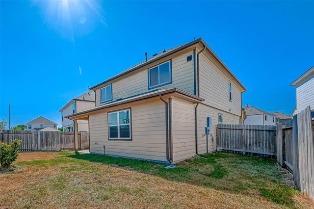 a view of a yard with wooden fence