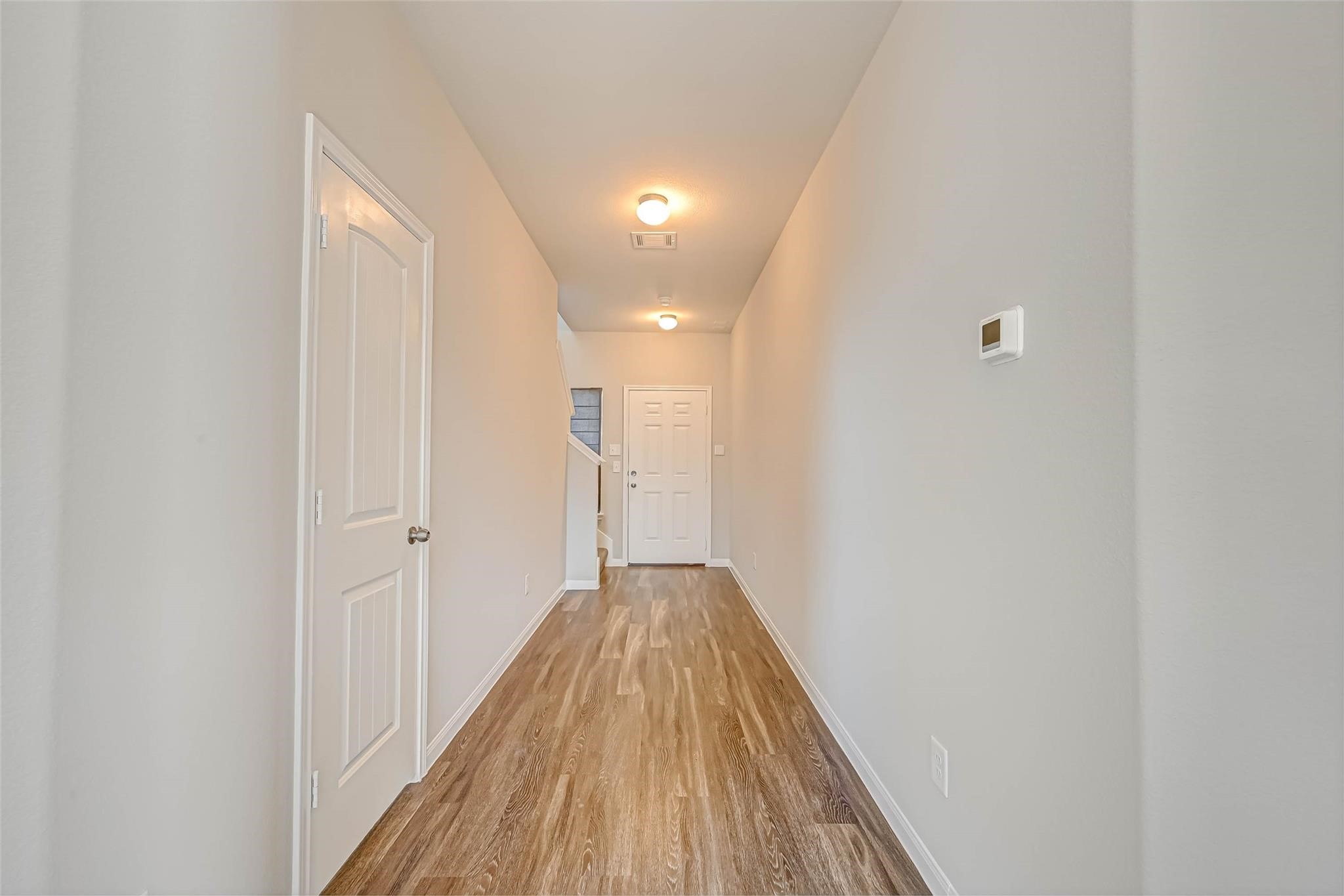 18606 Lansdowne Stream Path Katy, TX 77449 - Photo 6 of 39 a view of a hallway with wooden floor