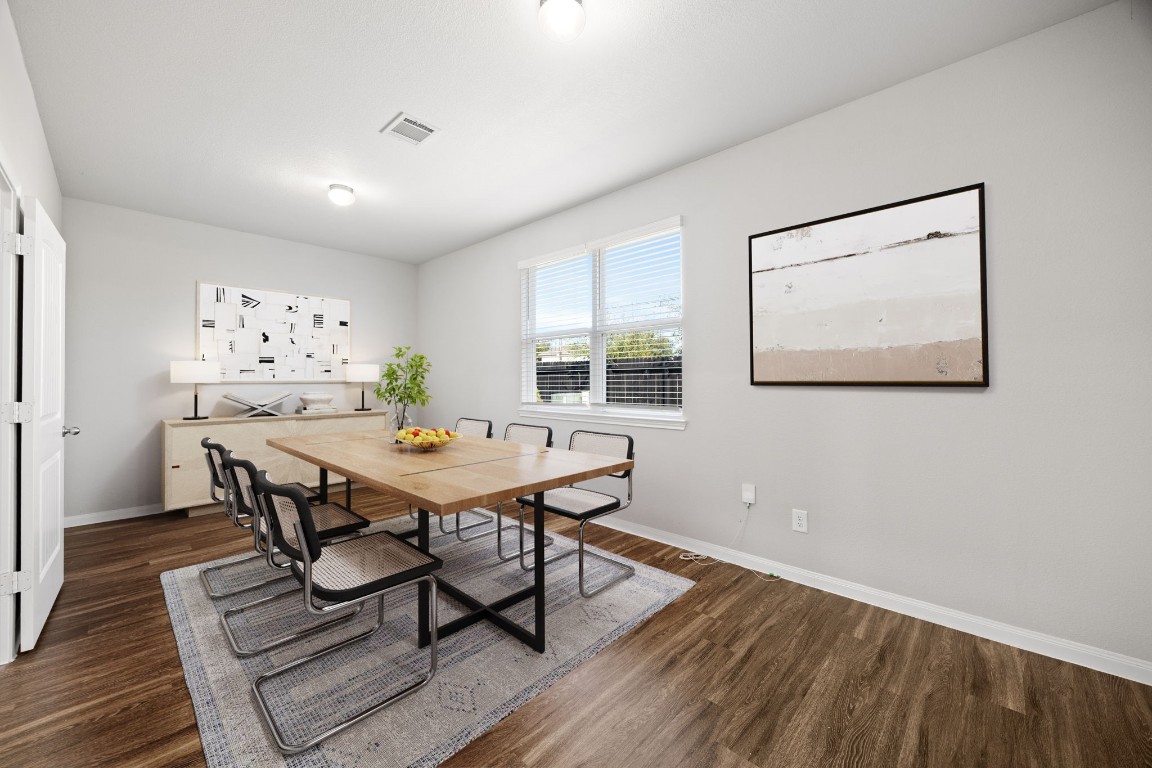 18606 Lansdowne Stream Path Katy, TX 77449 - Photo 9 of 39 Spacious separate dining room with large windows creating a bright and inviting atmosphere.