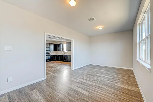 wooden floor in an empty room with a window