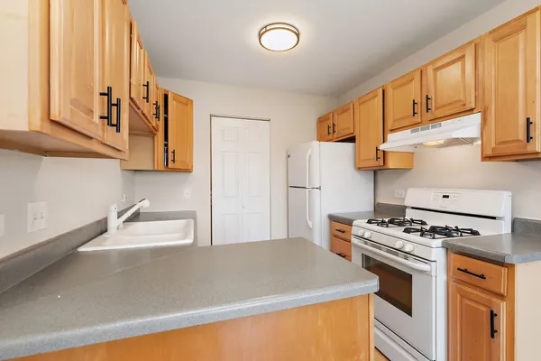 a kitchen with stainless steel appliances granite countertop a stove and a refrigerator