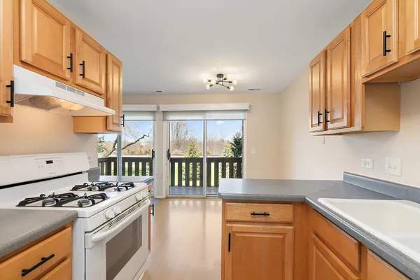 a kitchen with stainless steel appliances granite countertop a stove and a sink