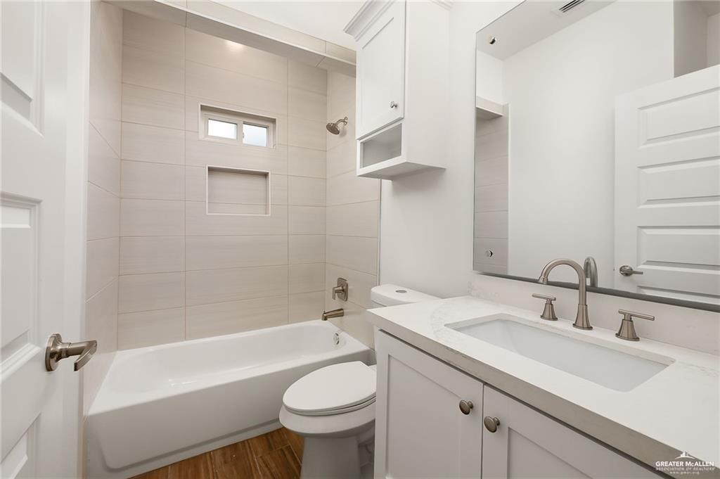 2110 Trinity Street Donna, TX 78537 - Photo 12 of 17 a bathroom with a sink a toilet and shower