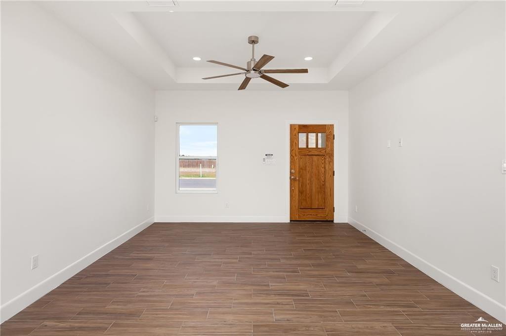 2110 Trinity Street Donna, TX 78537 - Photo 3 of 17 a view of an empty room with window and wooden floor