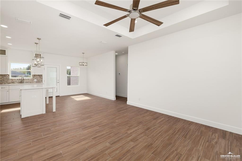 2110 Trinity Street Donna, TX 78537 - Photo 5 of 17 wooden floor in an empty room with a window