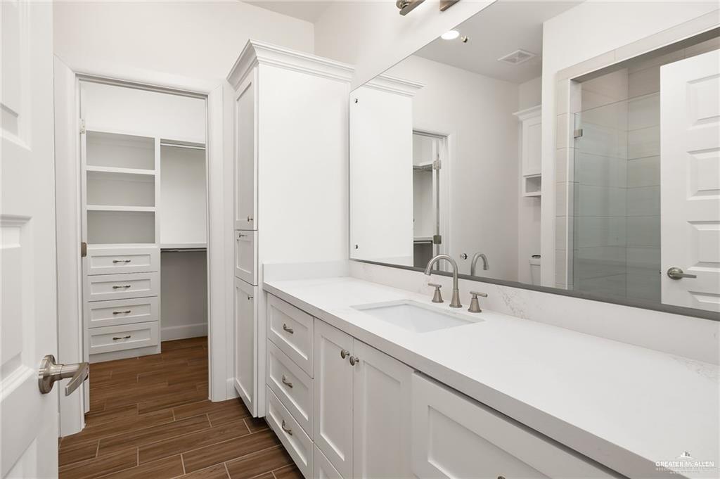 2110 Trinity Street Donna, TX 78537 - Photo 10 of 17 a bathroom with a double vanity sink a mirror and a shower