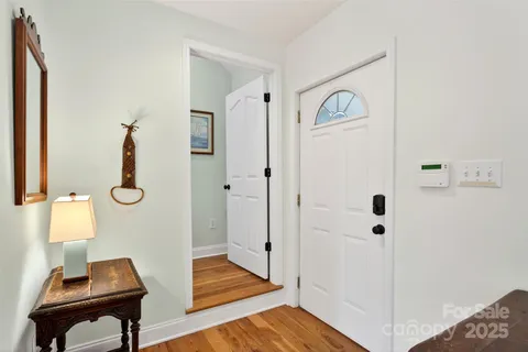 a view of an entryway with wooden floor