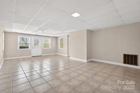 a backyard of a house with barbeque oven and outdoor seating