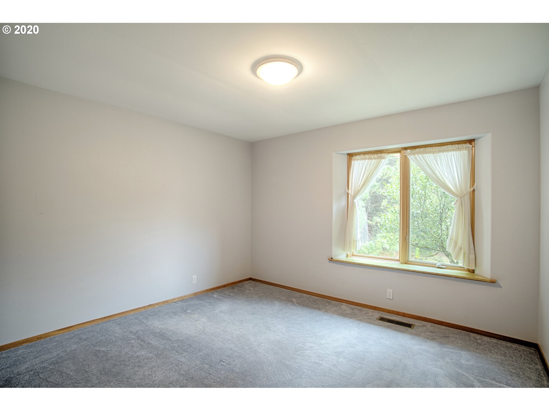 6315 Southeast Whiteson Road Amity, OR 97101 - Photo 12 of 30 a view of an empty room with wooden floor and a window