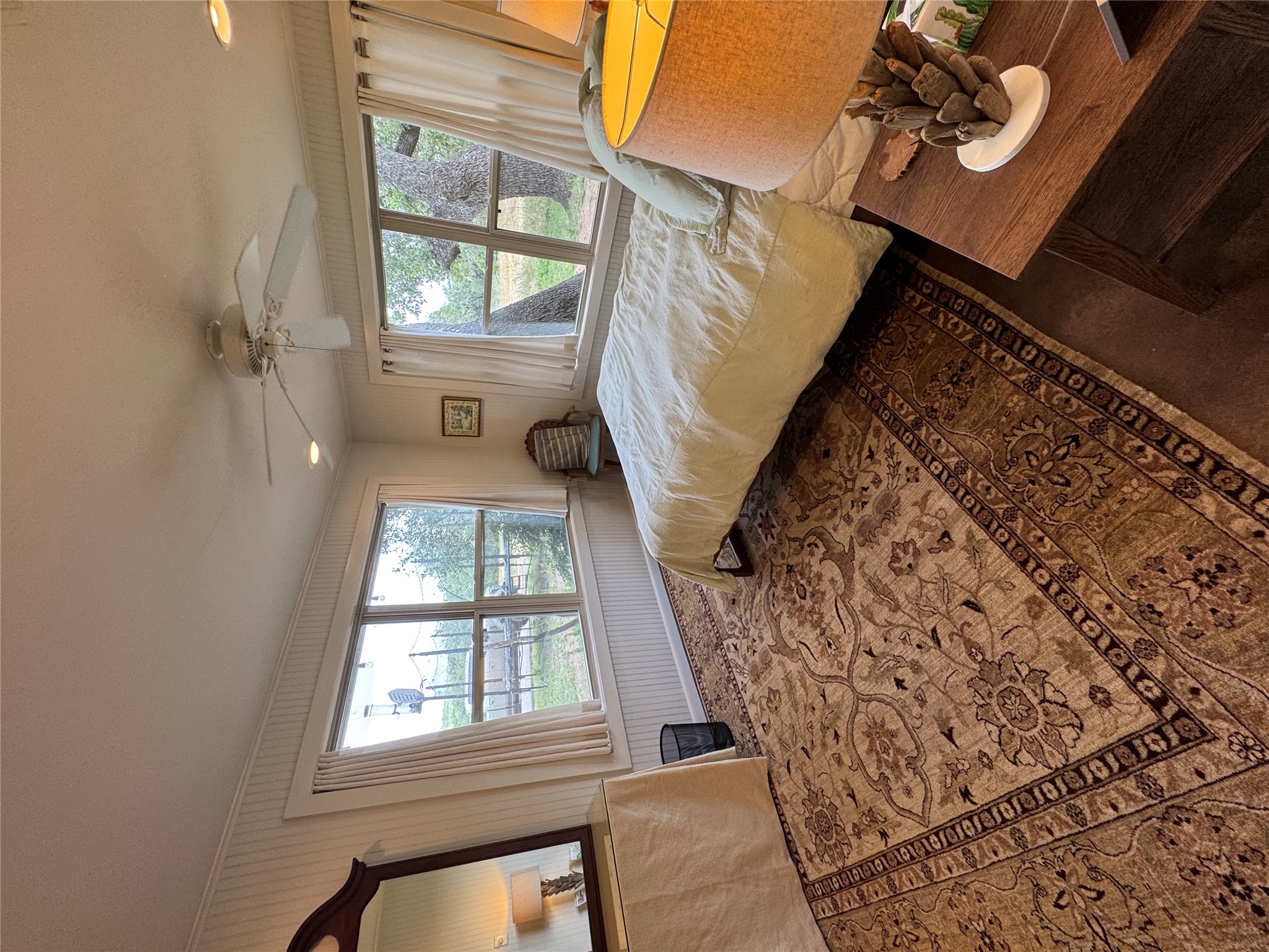 12501 Fitzhugh Road Austin, TX 78736 - Photo 23 of 40 Well-lit sleeping quarters with rich wood floors and multiple windows capturing natural light.