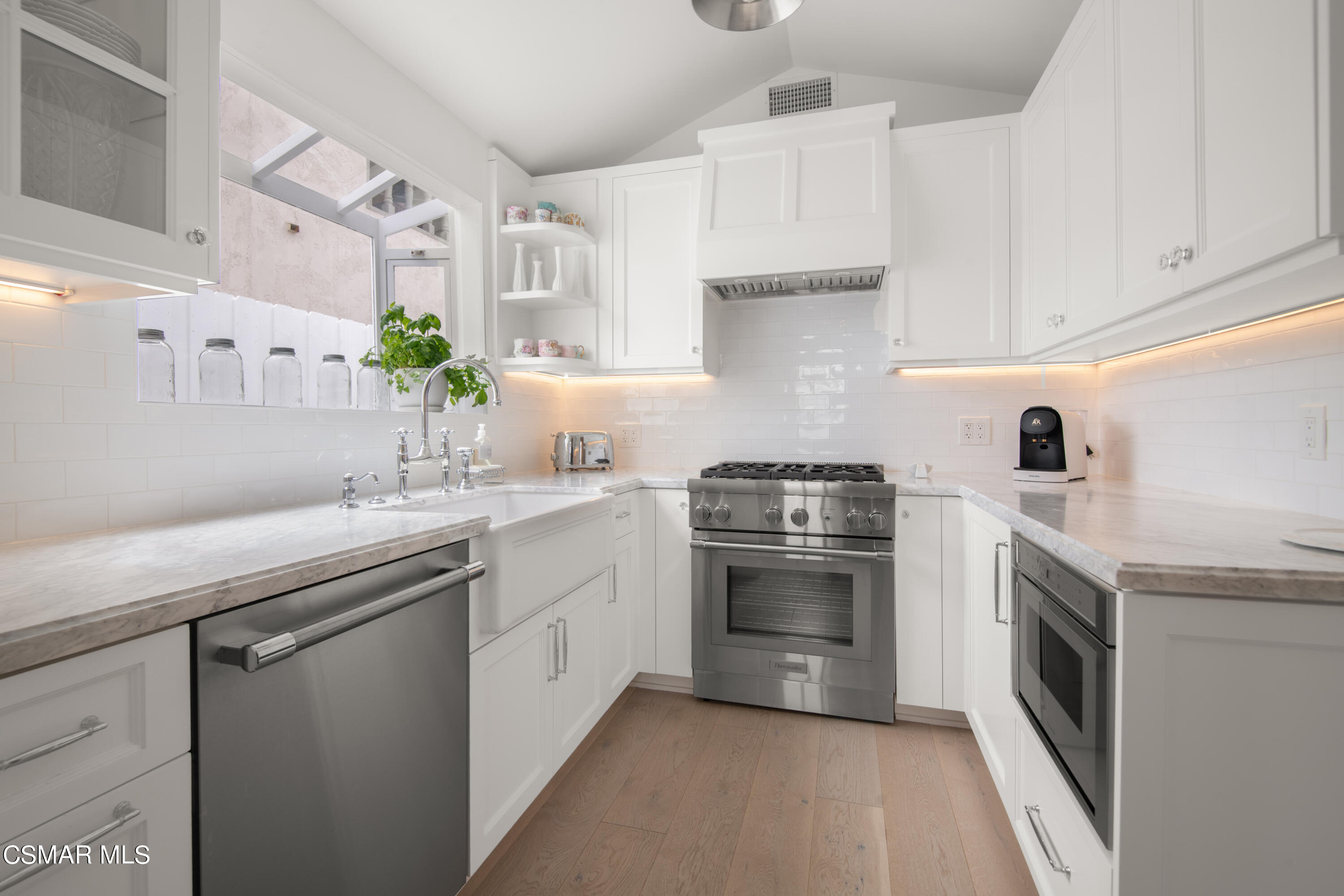 132 Santa Rosa Avenue Oxnard, CA 93035 - Photo 10 of 28 a kitchen with granite countertop white cabinets stainless steel appliances and sink