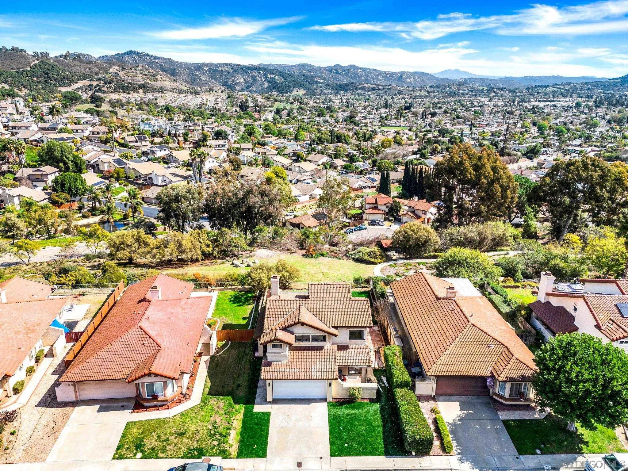 an aerial view of residential houses with outdoor space