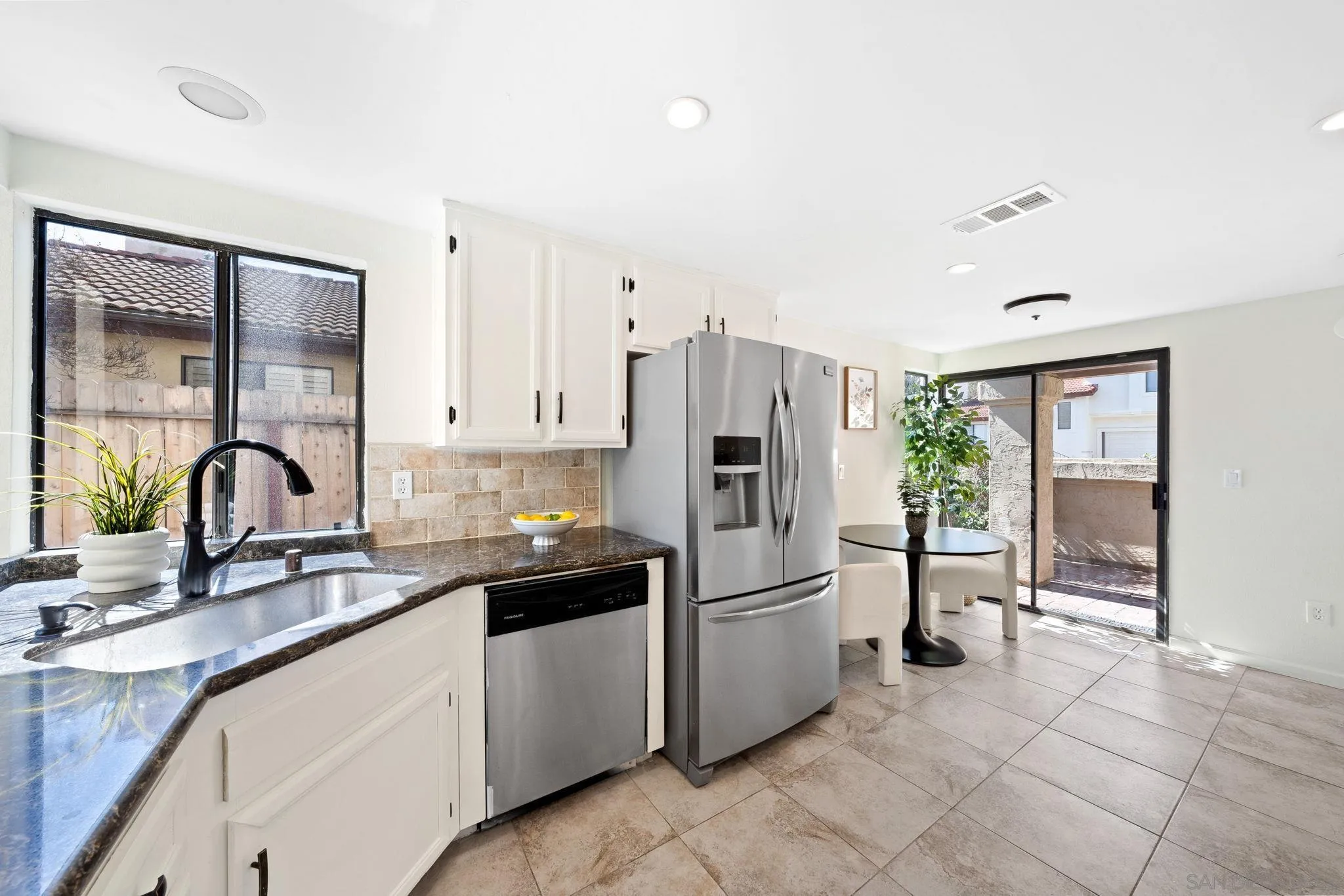 1436 Timber Escondido, CA 92027 - Photo 12 of 44 a kitchen with a sink a refrigerator and cabinets