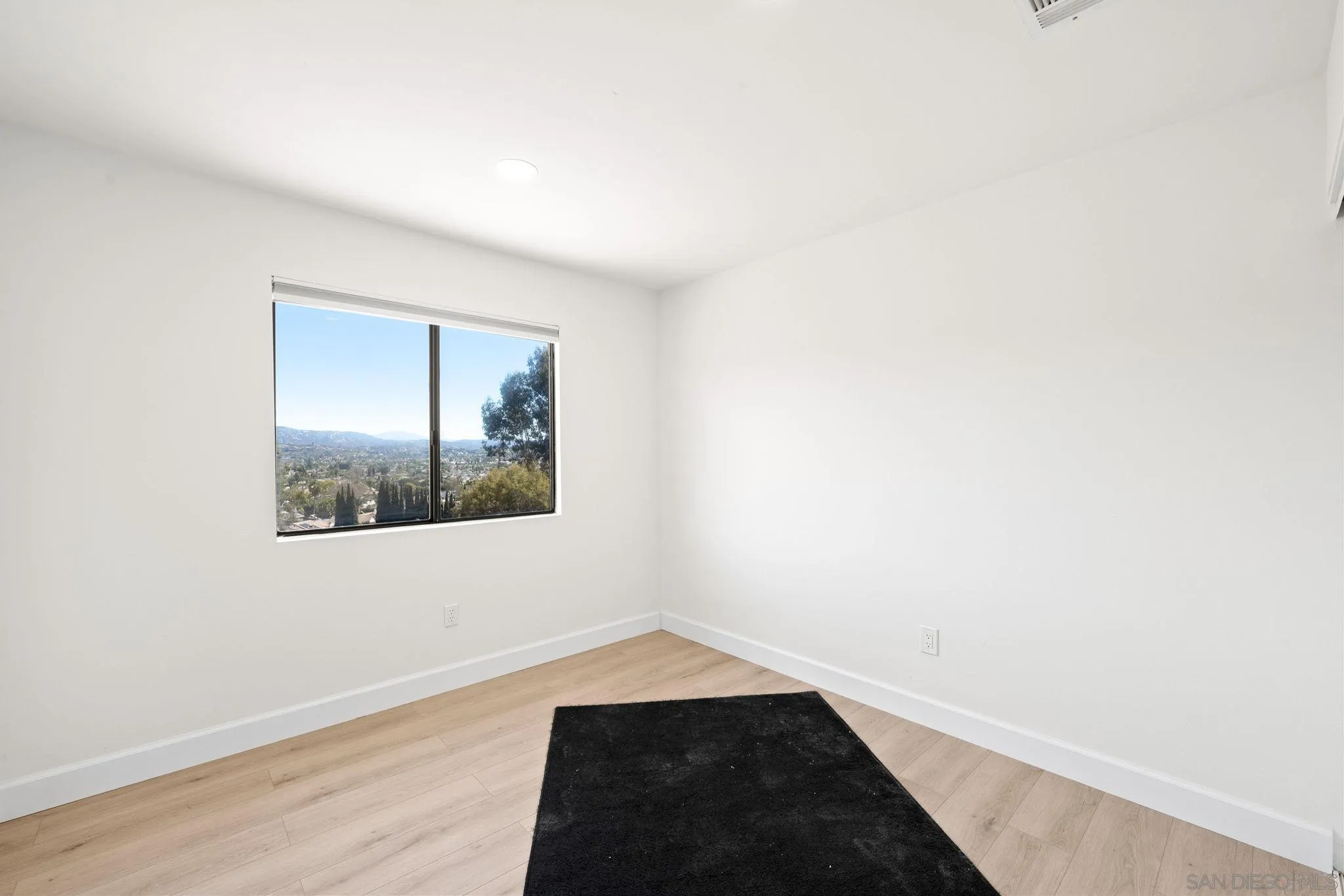 1436 Timber Escondido, CA 92027 - Photo 24 of 44 an empty room with wooden floor and windows