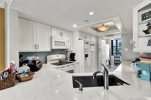 a view of a dining room with furniture and a chandelier