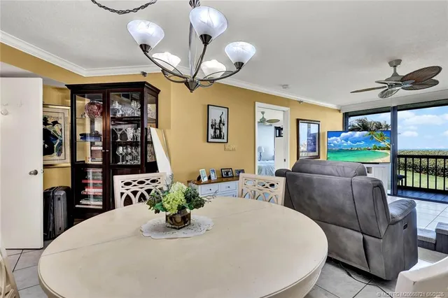 a living room with furniture a fireplace and a chandelier