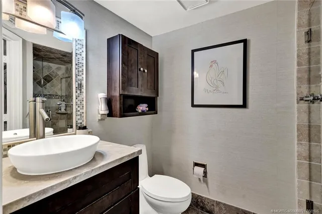 a spacious bedroom with two beds and a chandelier