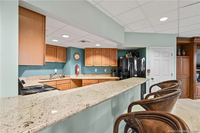 a view of a tennis ground with large trees