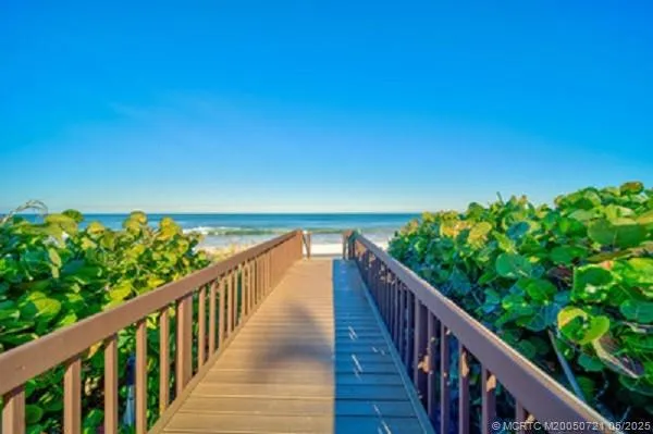 a view of a balcony with a yard