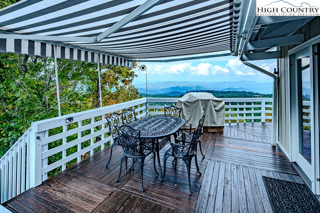 206 Pinnacle Ridge Road Beech Mountain, NC 28604 - Photo 17 of 41 a view of a chairs and table on the wooden roof deck