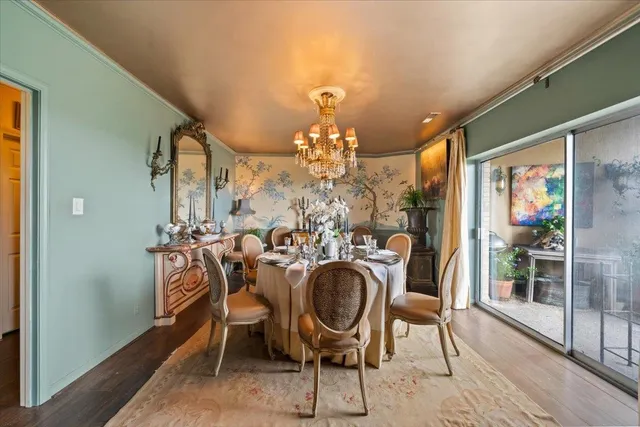 a view of a dining room with furniture and chandelier