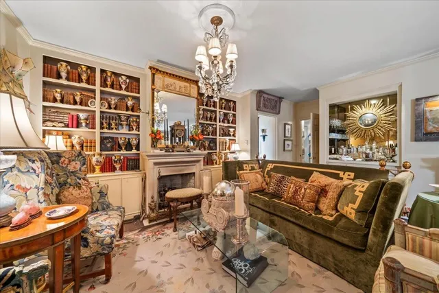 a living room with furniture a chandelier and large window