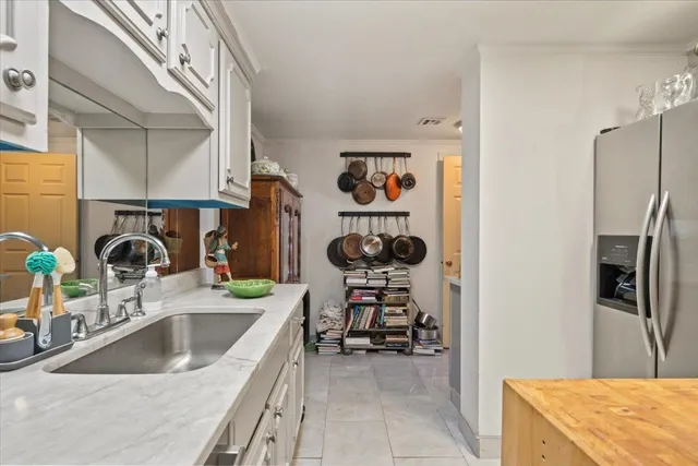 a kitchen with stainless steel appliances a sink a refrigerator and a sink