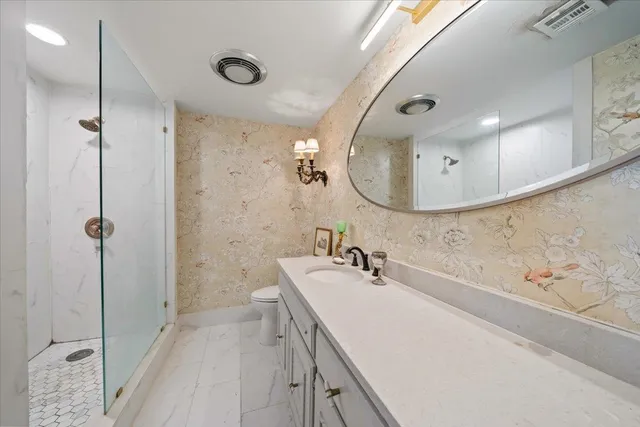 a bathroom with a double vanity sink mirror and shower