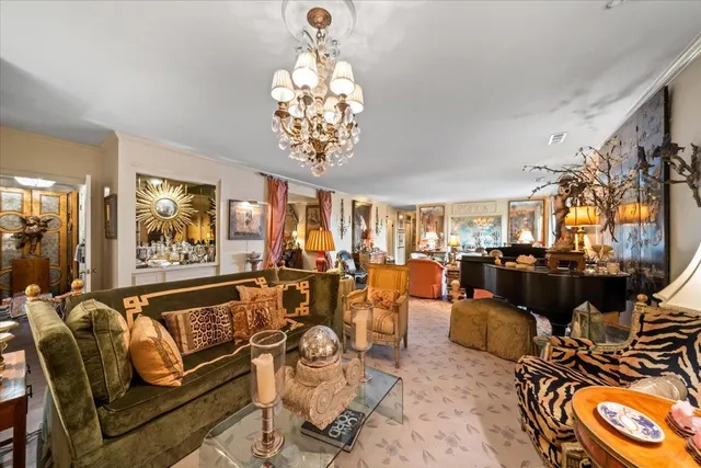 a living room with lots of furniture and chandelier