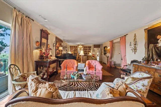 a living room with furniture kitchen view and large windows