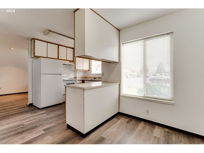 249 South 41st Place Springfield, OR 97478 - Photo 15 of 17 a kitchen with cabinets and wooden floor