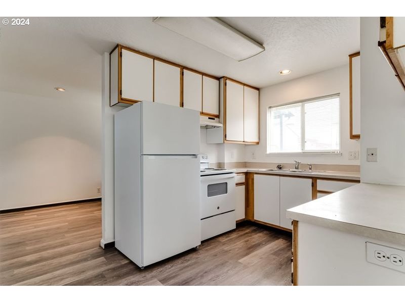 249 South 41st Place Springfield, OR 97478 - Photo 3 of 17 a kitchen with granite countertop white cabinets and white appliances