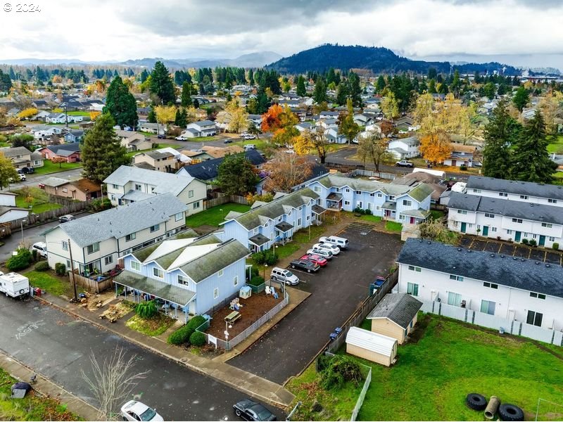 249 South 41st Place Springfield, OR 97478 - Photo 5 of 17 an aerial view of a city with lots of residential buildings ocean and mountain view in back