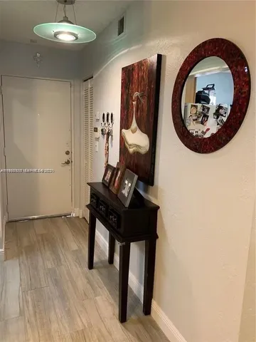 a view of a livingroom with furniture and mirror