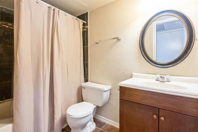 a bathroom with a toilet a sink and a mirror