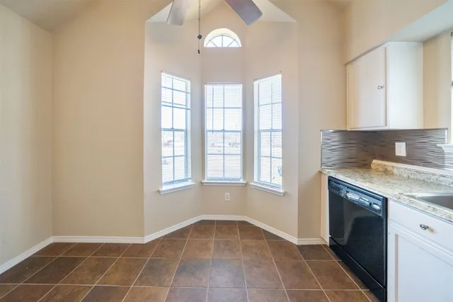 a view of an empty room with a kitchen