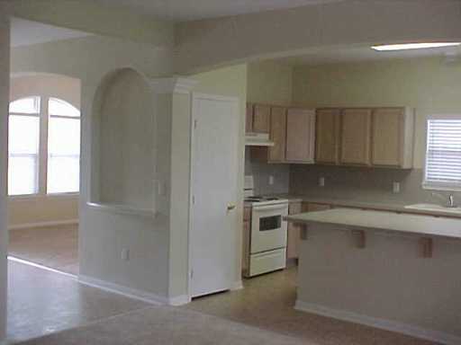 5809 Corsica Road Corpus Christi, TX 78414 - Photo 2 of 10 a kitchen with cabinets appliances a sink and a window