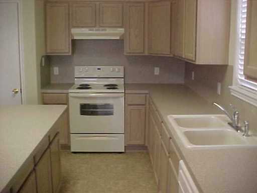5809 Corsica Road Corpus Christi, TX 78414 - Photo 8 of 10 a kitchen with white cabinets and white appliances