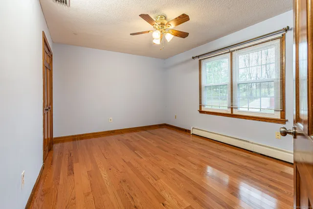 wooden floor in an empty room with a mirror