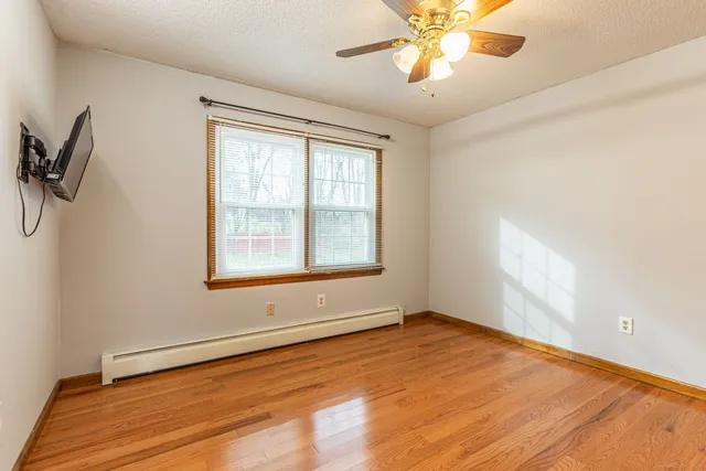 wooden floor in an empty room with a window