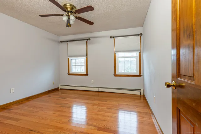 a bathroom with a granite countertop sink a toilet and a shower