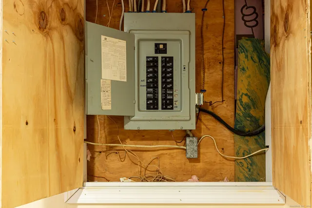 a view of a house with a big yard and large trees