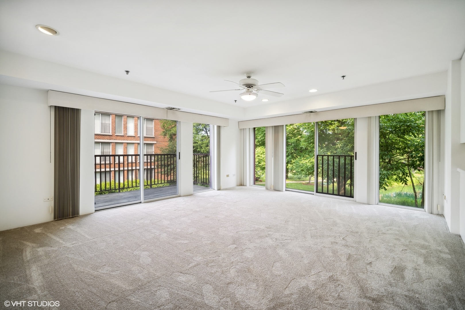 352 Kelburn Road, Unit 222 Deerfield, IL 60015 - Photo 5 of 21 a view of an empty room with windows and a ceiling fan