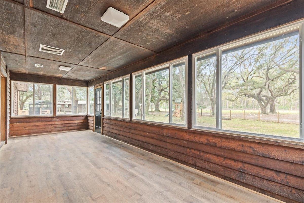4575 Carter Road St. Augustine, FL 32086 - Photo 49 of 90 a view of an empty room with wooden floor and a window