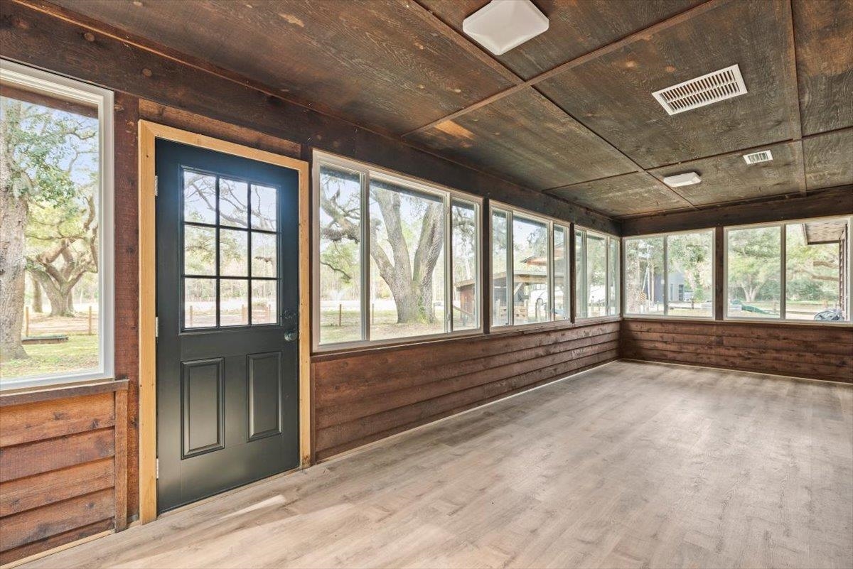 4575 Carter Road St. Augustine, FL 32086 - Photo 52 of 90 a view of an empty room with wooden floor and a window