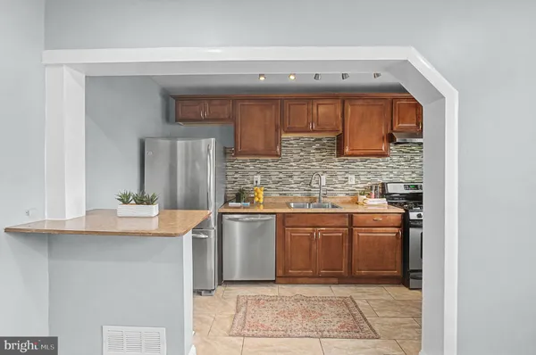 a kitchen with stainless steel appliances granite countertop a sink and cabinets