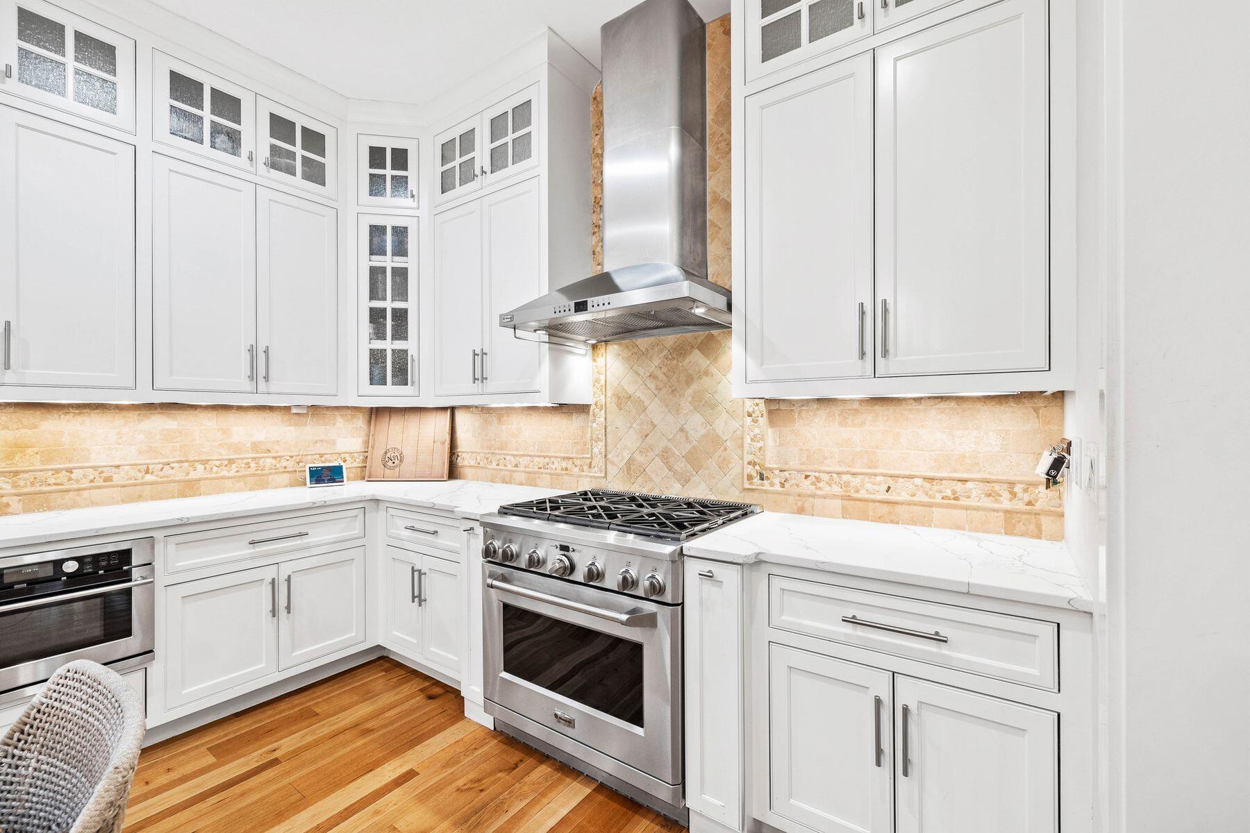 76 Tidepool Lane Watersound, FL 32461 - Photo 12 of 41 a kitchen with cabinets appliances and a wooden floor