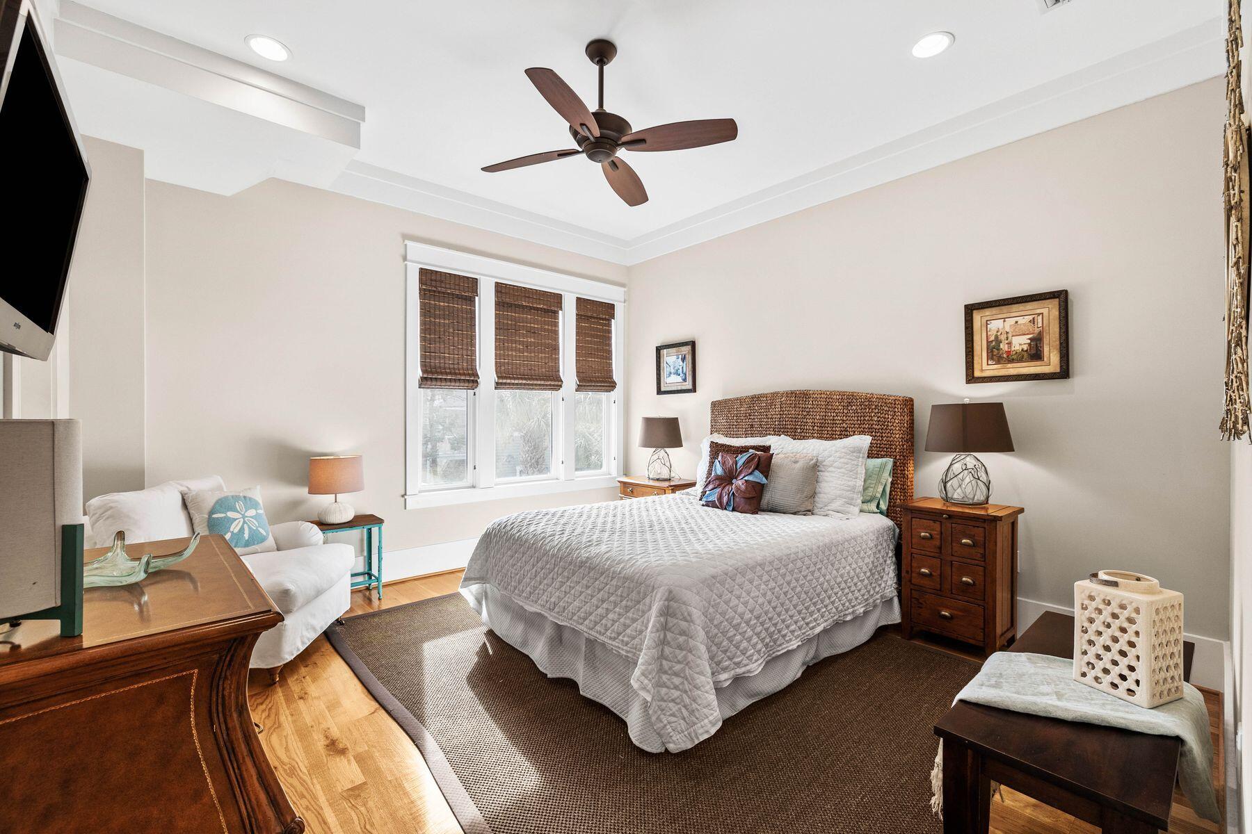76 Tidepool Lane Watersound, FL 32461 - Photo 18 of 41 a bedroom with a bed a window and a chandelier