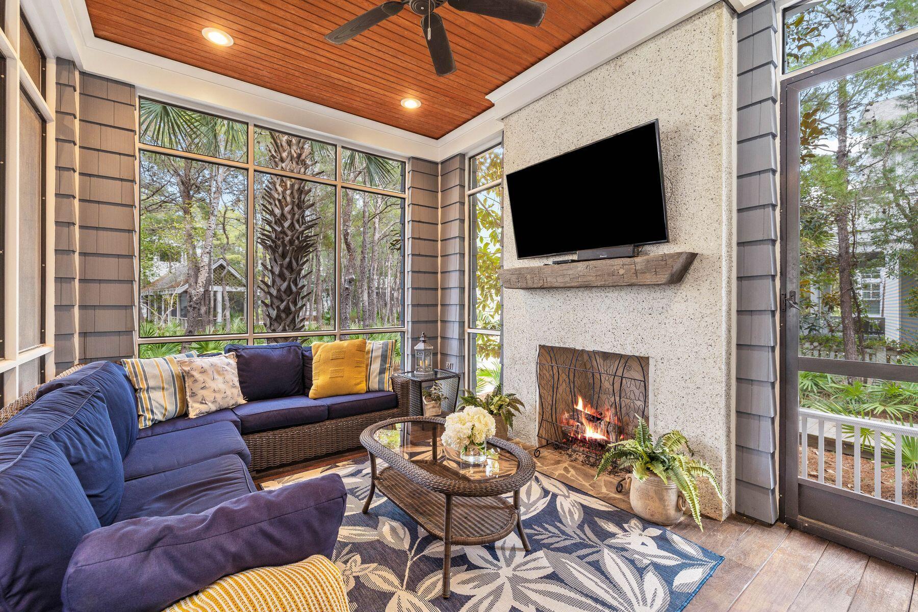 76 Tidepool Lane Watersound, FL 32461 - Photo 5 of 41 a living room with furniture a flat screen tv and a fireplace