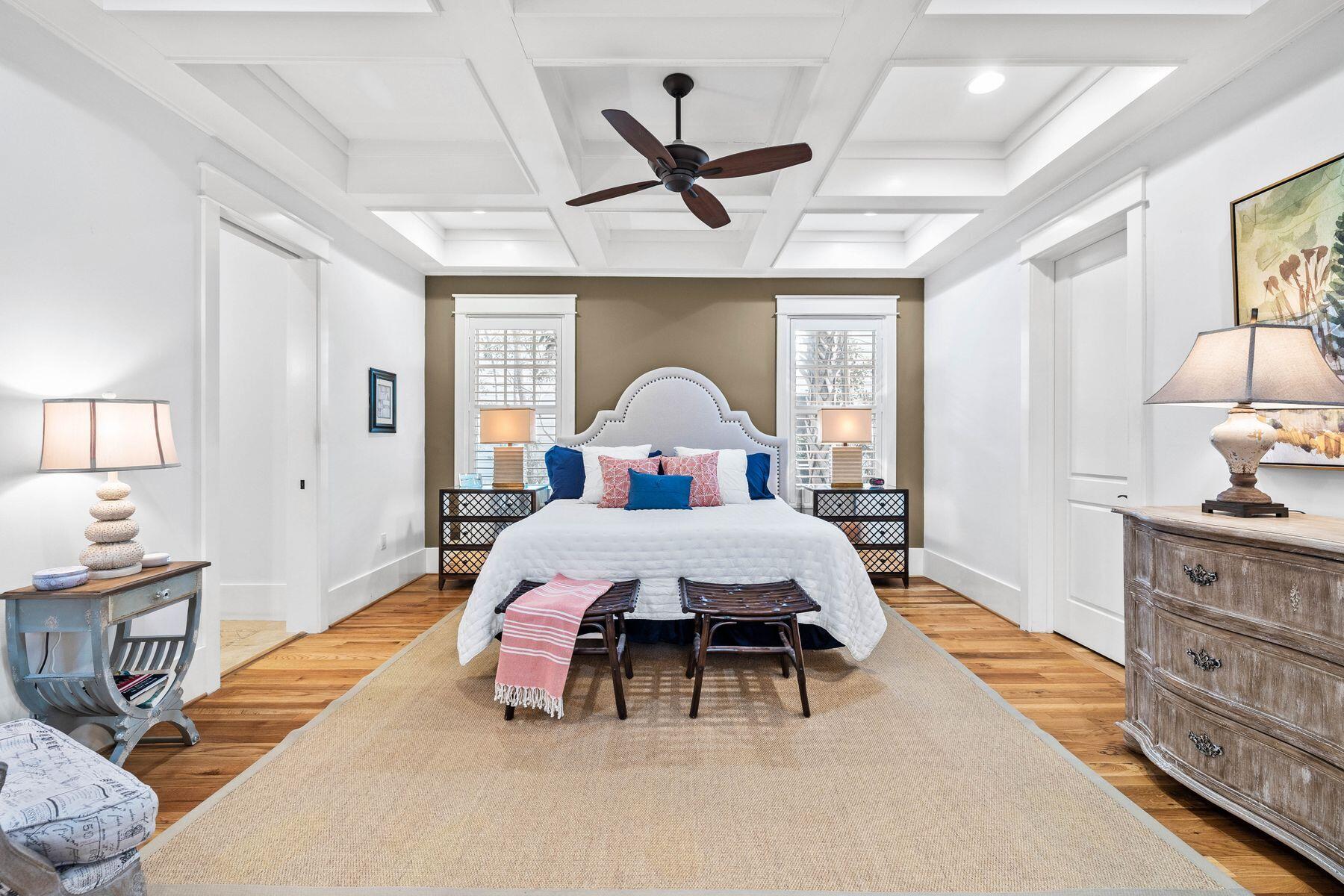 76 Tidepool Lane Watersound, FL 32461 - Photo 7 of 41 a spacious bedroom with a bed and a chandelier